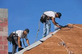 workers with harnes on the roof